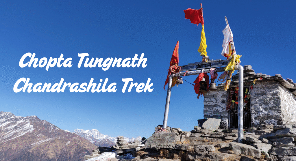 A trekker standing on the snow-covered Chandrashila summit overlooking the Himalayas. The Mountain Trekker